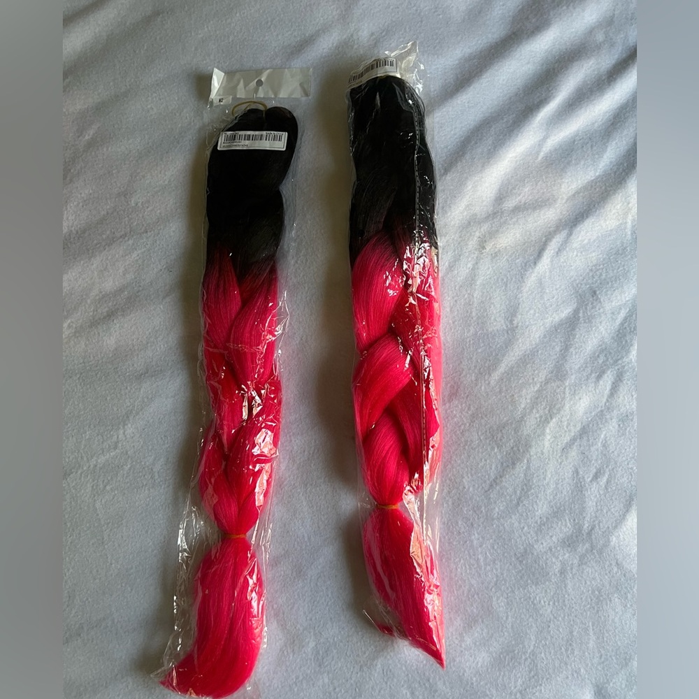 Pink and black braid-in hair extensions